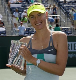 Maria Sharapova of Russia poses with a smaller replica trophy after defeating Caroline Wozniacki of Denmark in their women's singles final m Maria Sharapova of Russia poses with a smaller replica trophy after defeating Caroline Wozniacki of Denmark in their women's singles final m