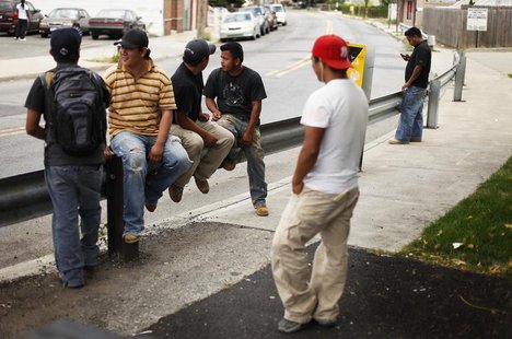 A group of immigrant day laborers stand near a street corner waiting for work in the Staten Island borough of New York August 3, 2010. REUTE A group of immigrant day laborers stand near a street corner waiting for work in the Staten Island borough of New York August 3, 2010. REUTE