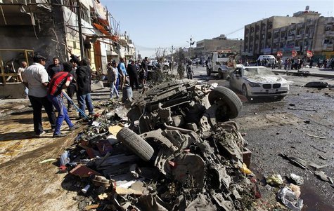 Residents gather at the site of a car bomb attack in the AL-Mashtal district in Baghdad March 19, 2013. A series of coordinated car bombs an Residents gather at the site of a car bomb attack in the AL-Mashtal district in Baghdad March 19, 2013. A series of coordinated car bombs an