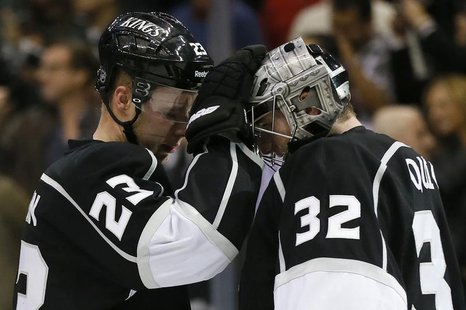 Los Angeles Kings captain Dustin Brown (L) celebrates with teammate goaltender Jonathan Quick after they defeated the Calgary Flames during Los Angeles Kings captain Dustin Brown (L) celebrates with teammate goaltender Jonathan Quick after they defeated the Calgary Flames during