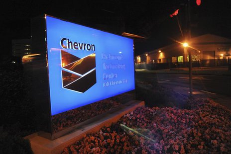A lit sign at Chevron's oil refinery in Richmond, California is seen through a window after a large fire erupted earlier in the evening on A A lit sign at Chevron's oil refinery in Richmond, California is seen through a window after a large fire erupted earlier in the evening on A