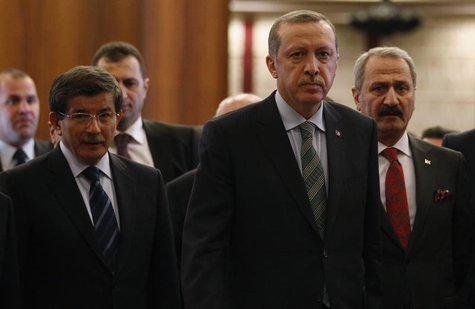 Turkey's Prime Minister Recep Tayyip Erdogan arrives for a news conference as he is flanked by Foreign Minister Ahmet Davutoglu (L), Economy Turkey's Prime Minister Recep Tayyip Erdogan arrives for a news conference as he is flanked by Foreign Minister Ahmet Davutoglu (L), Economy