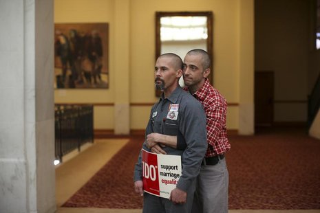 Same-sex couple Frank Capley (L) and Joe Alfano listen to a speaker at City Hall in San Francisco, California February 14, 2013. REUTERS/Rob Same-sex couple Frank Capley (L) and Joe Alfano listen to a speaker at City Hall in San Francisco, California February 14, 2013. REUTERS/Rob