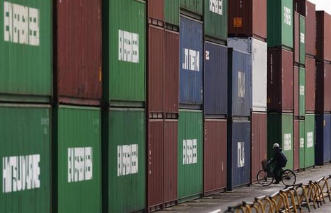 A man rides a bicycle next to containers at a port in Tokyo February 20, 2013.EUTERS/Yuya Shino A man rides a bicycle next to containers at a port in Tokyo February 20, 2013.EUTERS/Yuya Shino