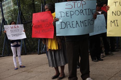 Activists hold posters during a demonstration calling for the government of U.S. President Barack Obama to stop deportations of Mexican and Activists hold posters during a demonstration calling for the government of U.S. President Barack Obama to stop deportations of Mexican and
