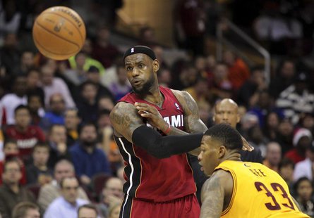 Miami Heat's LeBron James (L) passes the ball past Cleveland Cavaliers defender Alonzo Gee (33) during the third quarter of their NBA basket Miami Heat's LeBron James (L) passes the ball past Cleveland Cavaliers defender Alonzo Gee (33) during the third quarter of their NBA basket