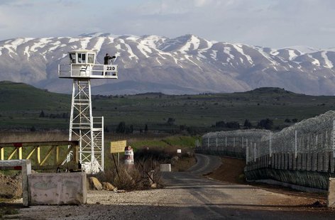 A United Nations peacekeeper stands on an observation tower at the Kuneitra border crossing between Israel and Syria, in the Israeli occupie A United Nations peacekeeper stands on an observation tower at the Kuneitra border crossing between Israel and Syria, in the Israeli occupie