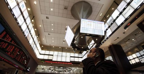 A man talks on his mobile phone as he looks at an electronic display board at Brazil's BM&FBovespa stock exchange in Sao Paulo August 4, 201 A man talks on his mobile phone as he looks at an electronic display board at Brazil's BM&FBovespa stock exchange in Sao Paulo August 4, 201