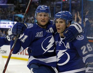 Tampa Bay Lightning's Steven Stamkos (L) celebrates his goal with teammate Martin St. Louis during the second period of their NHL hockey gam Tampa Bay Lightning's Steven Stamkos (L) celebrates his goal with teammate Martin St. Louis during the second period of their NHL hockey gam