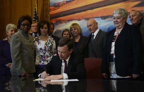 Colorado Governor John Hickenlooper signs three gun control bills into law in his office at the state capitol in Denver, Colorado, March, 20 Colorado Governor John Hickenlooper signs three gun control bills into law in his office at the state capitol in Denver, Colorado, March, 20