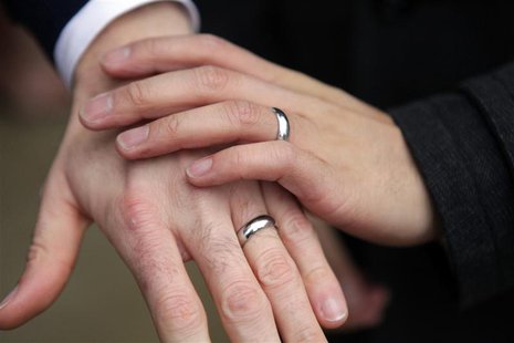 Bernie Liang (L), and Ryan Hamachek, show their rings after getting married outside Seattle City Hall in Seattle, Washington December 9, 201 Bernie Liang (L), and Ryan Hamachek, show their rings after getting married outside Seattle City Hall in Seattle, Washington December 9, 201