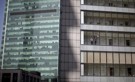 Men chat outside of an office of the Bocom Financial Tower at Pudong financial district in Shanghai March 21, 2013. REUTERS/Carlos Barria Men chat outside of an office of the Bocom Financial Tower at Pudong financial district in Shanghai March 21, 2013. REUTERS/Carlos Barria