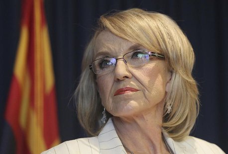 Arizona Governor Jan Brewer listens to a question from a media member about the Supreme Court's decision on SB1070 in Phoenix, Arizona, June Arizona Governor Jan Brewer listens to a question from a media member about the Supreme Court's decision on SB1070 in Phoenix, Arizona, June