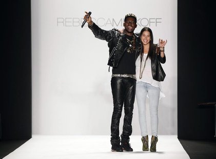 Designer Rebecca Minkoff smiles and waves with a musician after presenting her Fall/Winter 2012 collection during New York Fashion Week Febr Designer Rebecca Minkoff smiles and waves with a musician after presenting her Fall/Winter 2012 collection during New York Fashion Week Febr