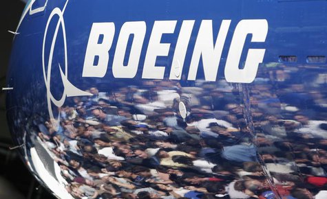 Invited guests for the world premiere of the Boeing 787 Dreamliner are reflected in the fuselage of the aircraft at the 787 assembly plant i Invited guests for the world premiere of the Boeing 787 Dreamliner are reflected in the fuselage of the aircraft at the 787 assembly plant i