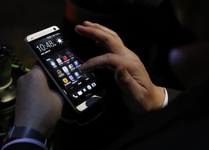 An attendee tests the new HTC One during a launch event in New York, February 19, 2013. REUTERS/Brendan McDermid An attendee tests the new HTC One during a launch event in New York, February 19, 2013. REUTERS/Brendan McDermid
