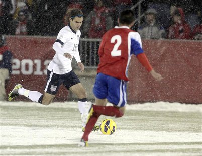 Graham Zusi of the U.S. (L) races past Costa Rica's Christian Gamboa (R) with the ball during their 2014 World Cup qualifying soccer match i Graham Zusi of the U.S. (L) races past Costa Rica's Christian Gamboa (R) with the ball during their 2014 World Cup qualifying soccer match i