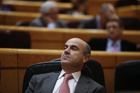 Spain's Economy Minister Luis de Guindos listens to a question during a session at the senate in Madrid, March 19, 2013. REUTERS/Juan Medina Spain's Economy Minister Luis de Guindos listens to a question during a session at the senate in Madrid, March 19, 2013. REUTERS/Juan Medina