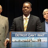 Lawyer Kevyn Orr (C) addresses the media, as Detroit Mayor Dave Bing (L) and Michigan Governor Rick Snyder listen, after Snyder announced Or