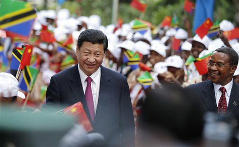 China's President Xi Jinping (L) and his Tanzanian counterpart Jakaya Kikwete (R) walk through women waving China and Tanzania national flag China's President Xi Jinping (L) and his Tanzanian counterpart Jakaya Kikwete (R) walk through women waving China and Tanzania national flag