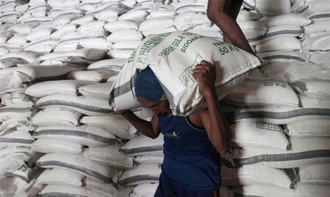 Workers load sacks of sugar from a warehouse onto a truck for distribution to the traders in Sidoarjo of Indonesia's East Java province Febr Workers load sacks of sugar from a warehouse onto a truck for distribution to the traders in Sidoarjo of Indonesia's East Java province Febr