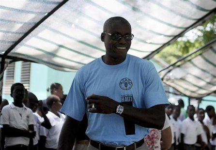 Carl Lewis (C), nine-time U.S. Olympic gold medalist and Goodwill Ambassador for the UN Food and Agriculture Organization (FAO), arrives at Carl Lewis (C), nine-time U.S. Olympic gold medalist and Goodwill Ambassador for the UN Food and Agriculture Organization (FAO), arrives at