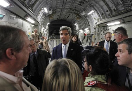 U.S. Secretary of State John Kerry (C) speaks to the media on an Air Force C-17 aircraft upon his return to Amman from a trip to Baghdad Mar U.S. Secretary of State John Kerry (C) speaks to the media on an Air Force C-17 aircraft upon his return to Amman from a trip to Baghdad Mar