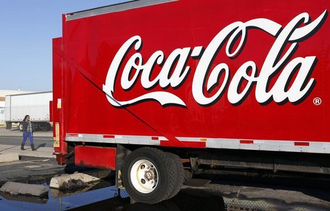 A woman walks past a Coca-Cola truck truck at a distribution center in Alexandria, Virginia October 16, 2012. REUTERS/Kevin Lamarque A woman walks past a Coca-Cola truck truck at a distribution center in Alexandria, Virginia October 16, 2012. REUTERS/Kevin Lamarque