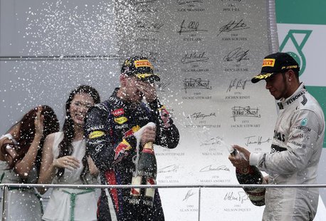 Third placed Mercedes Formula One driver Lewis Hamilton (R) of Britain sprays champagne at winner Red Bull Formula One driver Sebastian Vett Third placed Mercedes Formula One driver Lewis Hamilton (R) of Britain sprays champagne at winner Red Bull Formula One driver Sebastian Vett