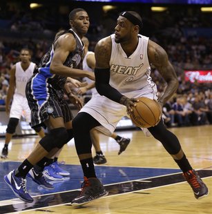 Miami Heat forward LeBron James (R) drives as he is defended by Orlando Magic forward Maurice Harkless (L)during the first half of their NBA Miami Heat forward LeBron James (R) drives as he is defended by Orlando Magic forward Maurice Harkless (L)during the first half of their NBA