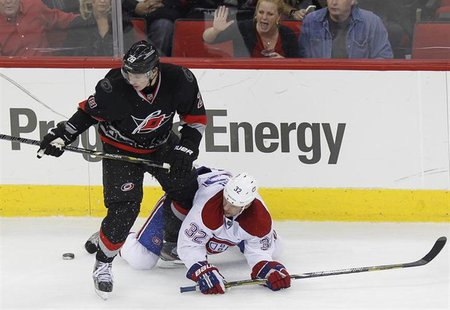 Carolina Hurricanes' Alexander Semin (L) battles Montreal Canadiens' Travis Moen for the puck during the third period of their NHL hockey ga Carolina Hurricanes' Alexander Semin (L) battles Montreal Canadiens' Travis Moen for the puck during the third period of their NHL hockey ga