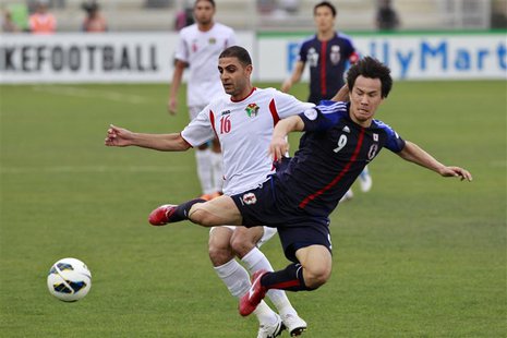 Japan's Shinji Okazaki (R) fights for the ball against Jordan's Basem Othman during their 2014 World Cup qualifying soccer match at King Abd Japan's Shinji Okazaki (R) fights for the ball against Jordan's Basem Othman during their 2014 World Cup qualifying soccer match at King Abd