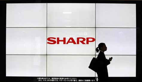 A woman walks past the Sharp Corp's Logo at a train station in Tokyo March 6, 2013. REUTERS/Yuya Shino A woman walks past the Sharp Corp's Logo at a train station in Tokyo March 6, 2013. REUTERS/Yuya Shino