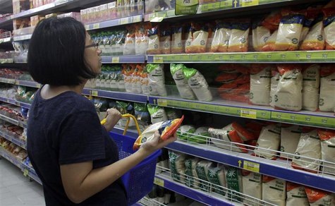 A woman examines the prices of white sugar displayed in a supermarket in Jakarta March 12, 2013. REUTERS/Supri A woman examines the prices of white sugar displayed in a supermarket in Jakarta March 12, 2013. REUTERS/Supri