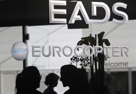 Visitors talk near the welcome desk of the EADS booth at the ILA Berlin Air Show in Selchow near Schoenefeld south of Berlin on September 13 Visitors talk near the welcome desk of the EADS booth at the ILA Berlin Air Show in Selchow near Schoenefeld south of Berlin on September 13