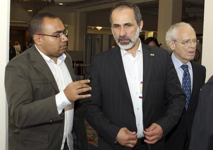 Syrian National Coalition leader Moaz Alkhatib (C) speaks to journalists during the Arab League summit in Doha March 26, 2013. REUTERS/Strin Syrian National Coalition leader Moaz Alkhatib (C) speaks to journalists during the Arab League summit in Doha March 26, 2013. REUTERS/Strin