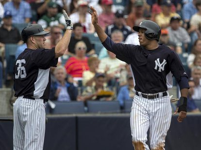 New York Yankees' Thomas Neal (R) celebrates with teammate Kevin Youkilis after scoring against the Boston Red Sox during the second inning New York Yankees' Thomas Neal (R) celebrates with teammate Kevin Youkilis after scoring against the Boston Red Sox during the second inning