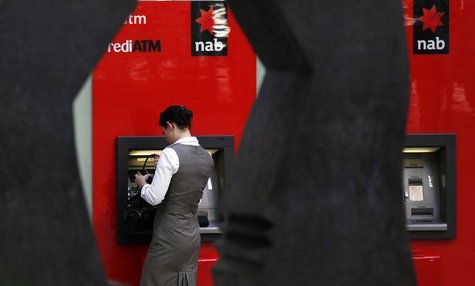A woman uses a National Australia Bank (NAB) ATM in central Sydney May 5, 2011. REUTERS/Daniel Munoz A woman uses a National Australia Bank (NAB) ATM in central Sydney May 5, 2011. REUTERS/Daniel Munoz