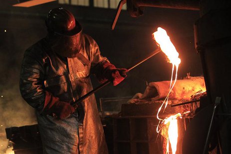 Bernard Mickael, 35, from France, worker at Belgian company Picanol, demonstrates to Reuters journalists how iron is melted for the company' Bernard Mickael, 35, from France, worker at Belgian company Picanol, demonstrates to Reuters journalists how iron is melted for the company'
