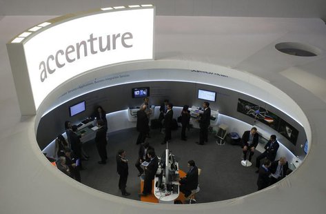 Visitors look at devices at Accenture stand at the Mobile World Congress in Barcelona, February 26, 2013. REUTERS/Albert Gea Visitors look at devices at Accenture stand at the Mobile World Congress in Barcelona, February 26, 2013. REUTERS/Albert Gea