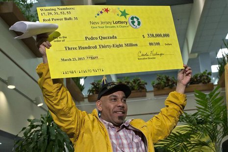 Pedro Quezada holds up the promotional Powerball jackpot check of $338 million at the end of a news conference at the New Jersey Lottery hea Pedro Quezada holds up the promotional Powerball jackpot check of $338 million at the end of a news conference at the New Jersey Lottery hea