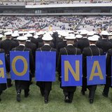 Midshipmen from the United States Naval Academy display placards on their backs as the exit field before the start of the Army versus Navy N Midshipmen from the United States Naval Academy display placards on their backs as the exit field before the start of the Army versus Navy N