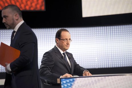 France's President Francois Hollande sits with his notes before appearing on France 2 television prime time news broadcast for an interview France's President Francois Hollande sits with his notes before appearing on France 2 television prime time news broadcast for an interview