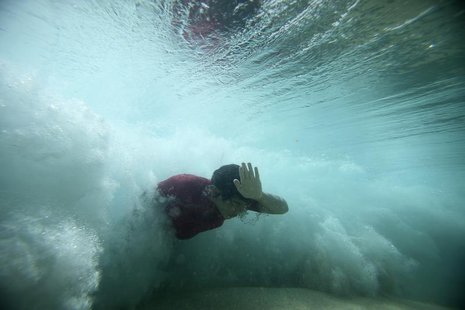 A bodysurfer punches through a wave at the Ehukai sandbar near the surf break known as 'Pipeline' on the North Shore of Oahu, Hawaii March 2 A bodysurfer punches through a wave at the Ehukai sandbar near the surf break known as 'Pipeline' on the North Shore of Oahu, Hawaii March 2