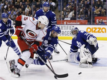 Toronto Maple Leafs goalie James Reimer (R) looks on with teammate Nazem Kadri (C) against Carolina Hurricanes Tuomo Ruutu during the third Toronto Maple Leafs goalie James Reimer (R) looks on with teammate Nazem Kadri (C) against Carolina Hurricanes Tuomo Ruutu during the third