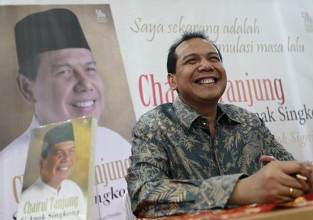 Founder and chairman CT Corp Chairul Tanjung smiles as his sits in front of his portrait at a book shop during his book launch in Jakarta Ju Founder and chairman CT Corp Chairul Tanjung smiles as his sits in front of his portrait at a book shop during his book launch in Jakarta Ju