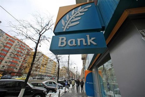 People walk past a branch of the Bank of Cyprus in Bucharest March 28, 2013. REUTERS/Radu Sigheti People walk past a branch of the Bank of Cyprus in Bucharest March 28, 2013. REUTERS/Radu Sigheti