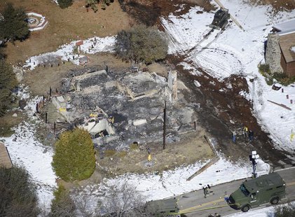 Authorities stand at the site of a burnt out cabin near Angelus Oaks, California February 13, 2013, where police believe they engaged in a s Authorities stand at the site of a burnt out cabin near Angelus Oaks, California February 13, 2013, where police believe they engaged in a s