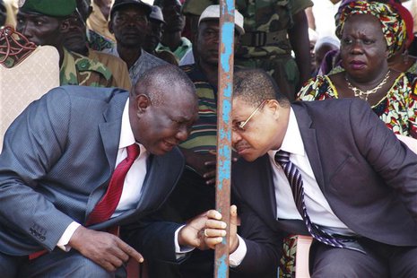 Central African Republic's new President Michel Djotodia (L) speaks to Prime Minister Nicolas Tiangaye at a rally in support of Djotodia in Central African Republic's new President Michel Djotodia (L) speaks to Prime Minister Nicolas Tiangaye at a rally in support of Djotodia in