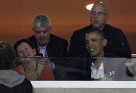 U.S. President Barack Obama (R) watches an NCAA basketball game between Syracuse Orange and Marquette Golden Eagles in Washington March 30, U.S. President Barack Obama (R) watches an NCAA basketball game between Syracuse Orange and Marquette Golden Eagles in Washington March 30,